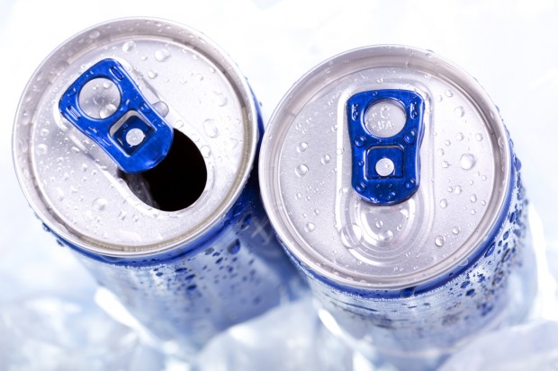 An overhead view of two cans of energy drinks, sitting in ice.