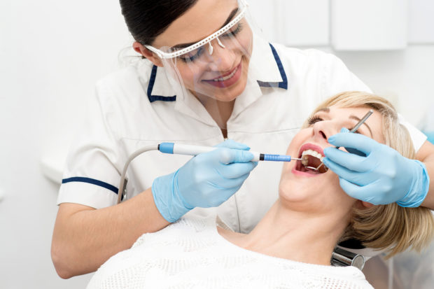 Dentist dutifully eliminates harmful bacteria